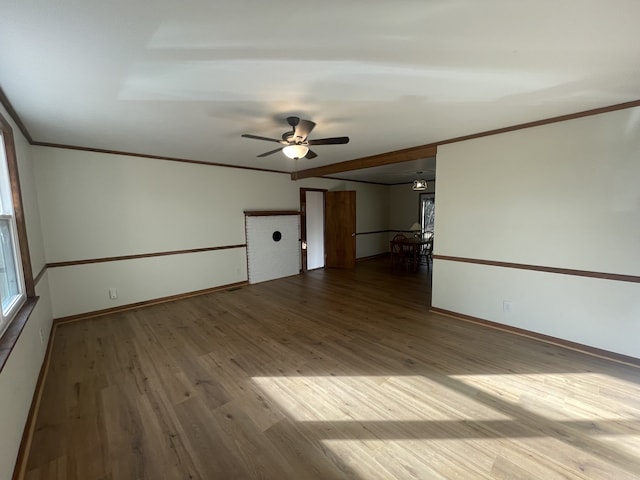 empty room with hardwood / wood-style flooring, ceiling fan, and crown molding