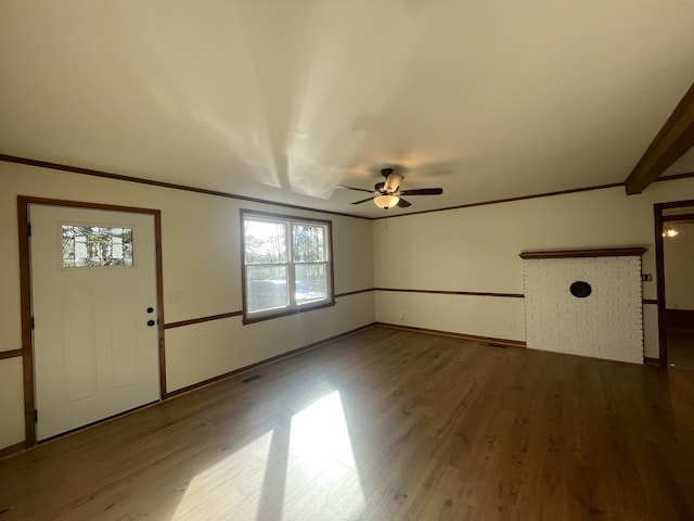 interior space featuring ceiling fan, wood-type flooring, and beam ceiling