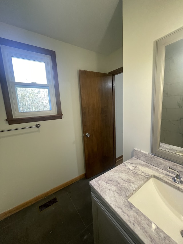 bathroom featuring tile patterned flooring and vanity