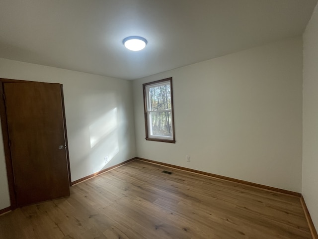 spare room featuring light hardwood / wood-style flooring