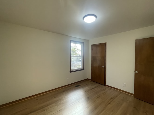 spare room featuring light wood-type flooring