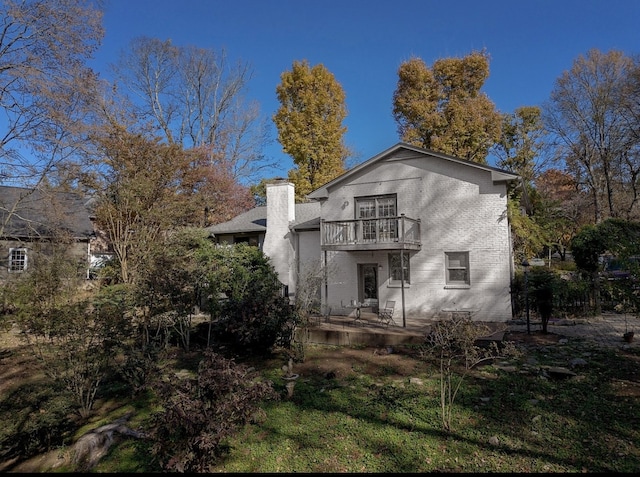 back of house with a deck