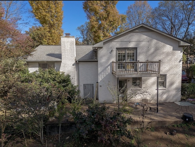 back of property featuring a patio area and a balcony