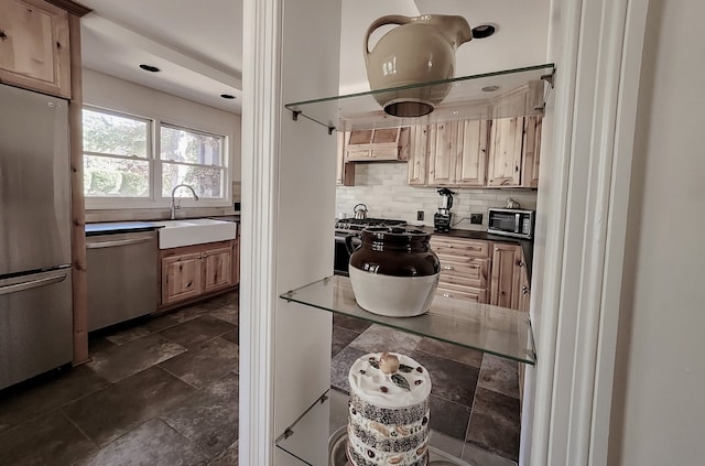 kitchen featuring custom range hood, stainless steel appliances, sink, light brown cabinetry, and tasteful backsplash