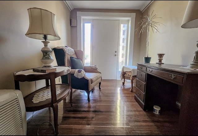 sitting room featuring ornamental molding and dark hardwood / wood-style flooring