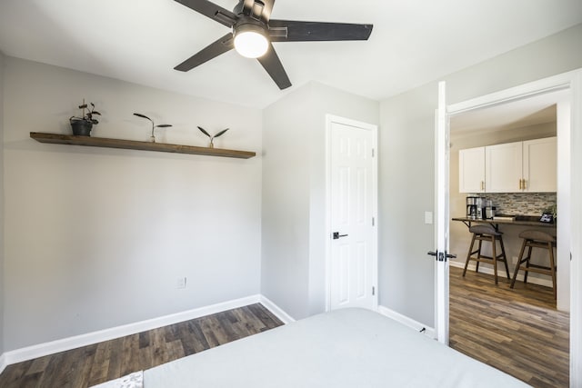 bedroom featuring ceiling fan and dark hardwood / wood-style flooring