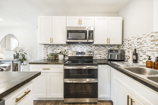 kitchen featuring white cabinetry, stainless steel appliances, and dark hardwood / wood-style flooring