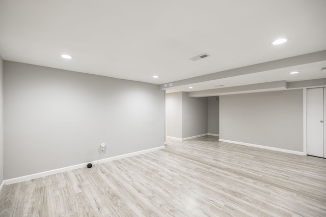 basement with light hardwood / wood-style floors