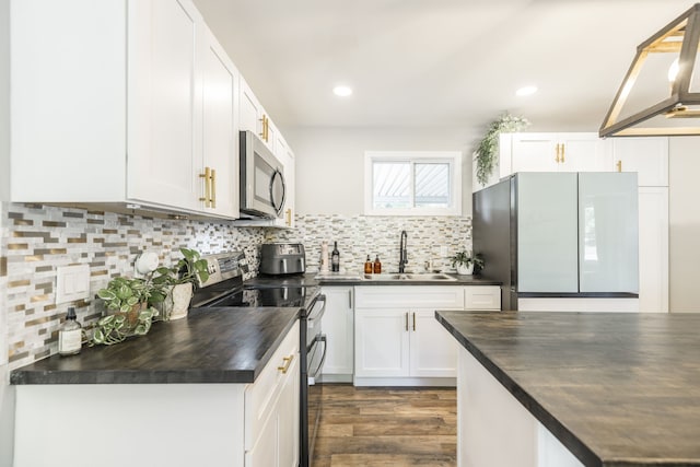 kitchen with white cabinets, electric range, dark wood-type flooring, refrigerator, and sink