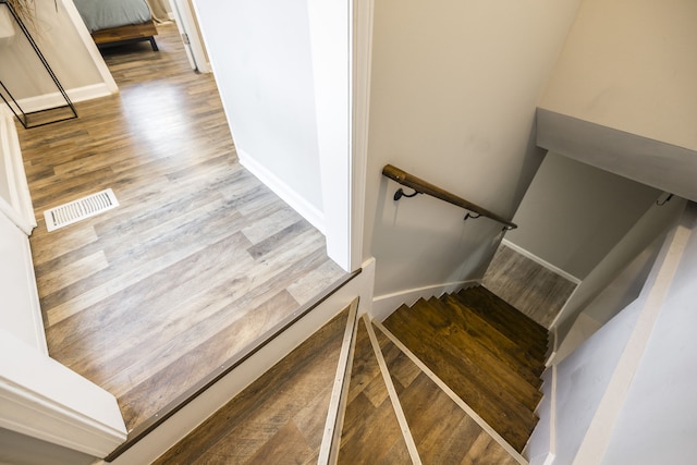 stairway featuring hardwood / wood-style flooring