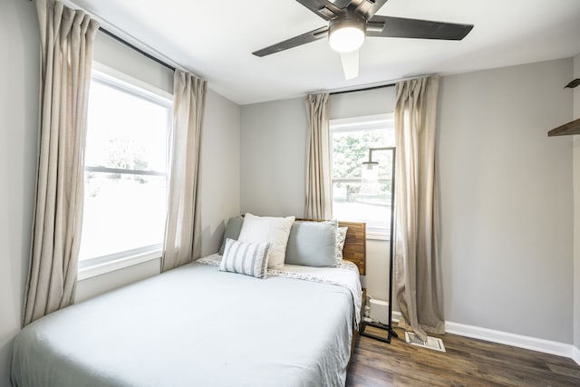 bedroom with ceiling fan and dark hardwood / wood-style floors