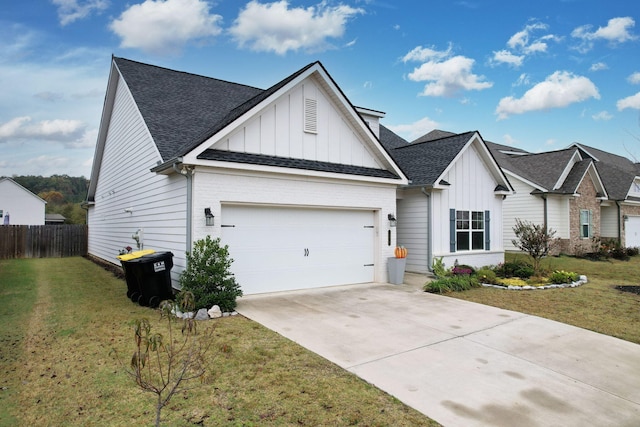 view of front of home with a front yard and a garage