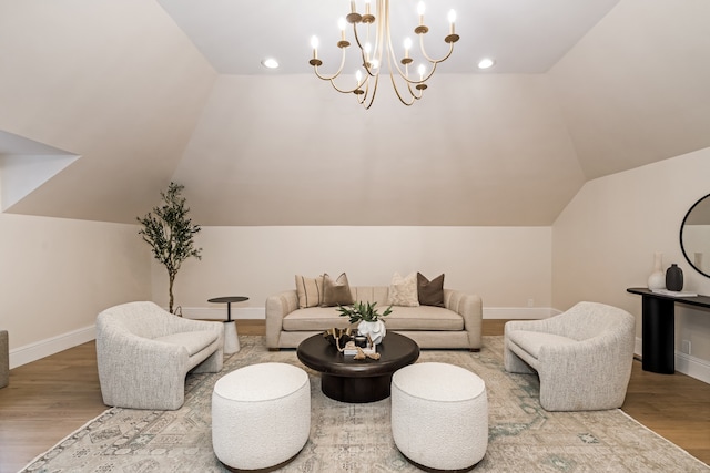 living room featuring a chandelier, wood-type flooring, and lofted ceiling