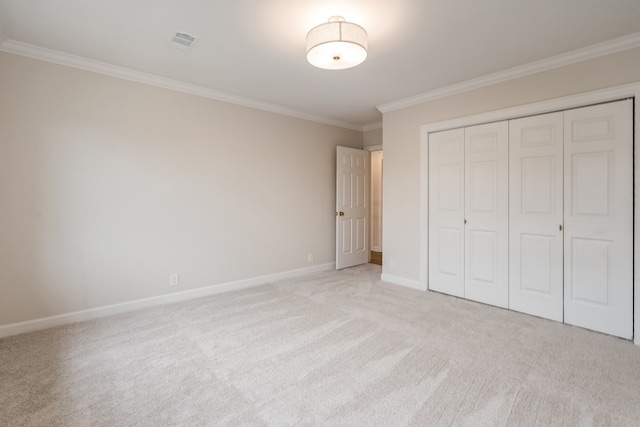 unfurnished bedroom with light colored carpet, ornamental molding, and a closet