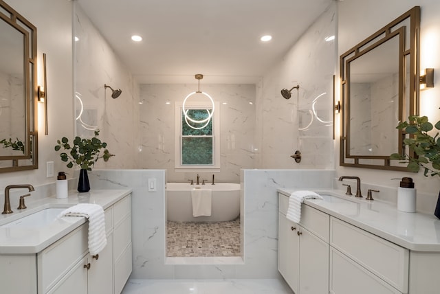 bathroom featuring a washtub and vanity