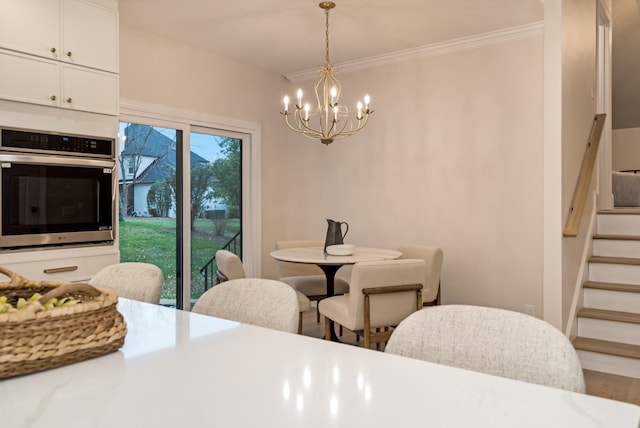 dining area featuring wood-type flooring, a chandelier, and ornamental molding