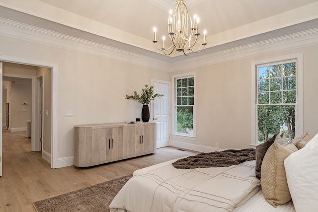 bedroom featuring light hardwood / wood-style floors, multiple windows, ornamental molding, and a notable chandelier