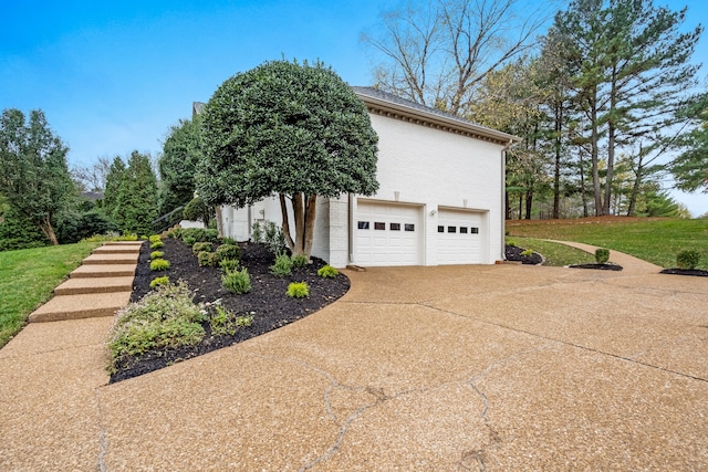 view of side of property featuring a yard and a garage