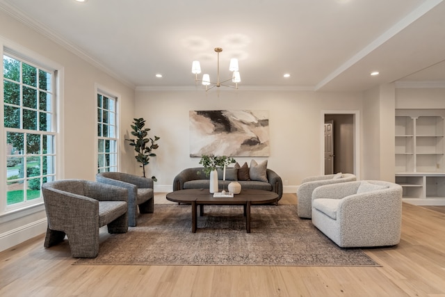 living room featuring light hardwood / wood-style floors, crown molding, and a chandelier