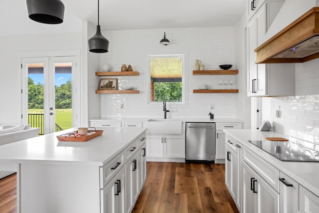 kitchen featuring backsplash, dishwasher, black electric cooktop, and hanging light fixtures