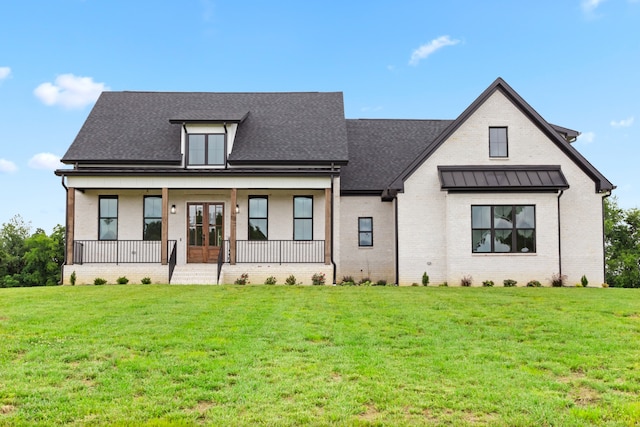 view of front of property featuring french doors and a front yard