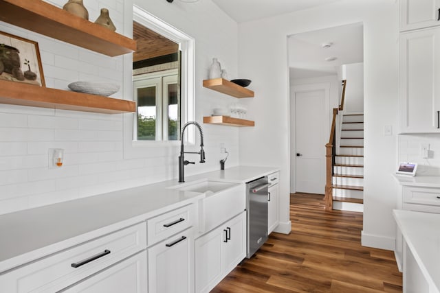 kitchen featuring white cabinetry, tasteful backsplash, dark wood-type flooring, and stainless steel dishwasher