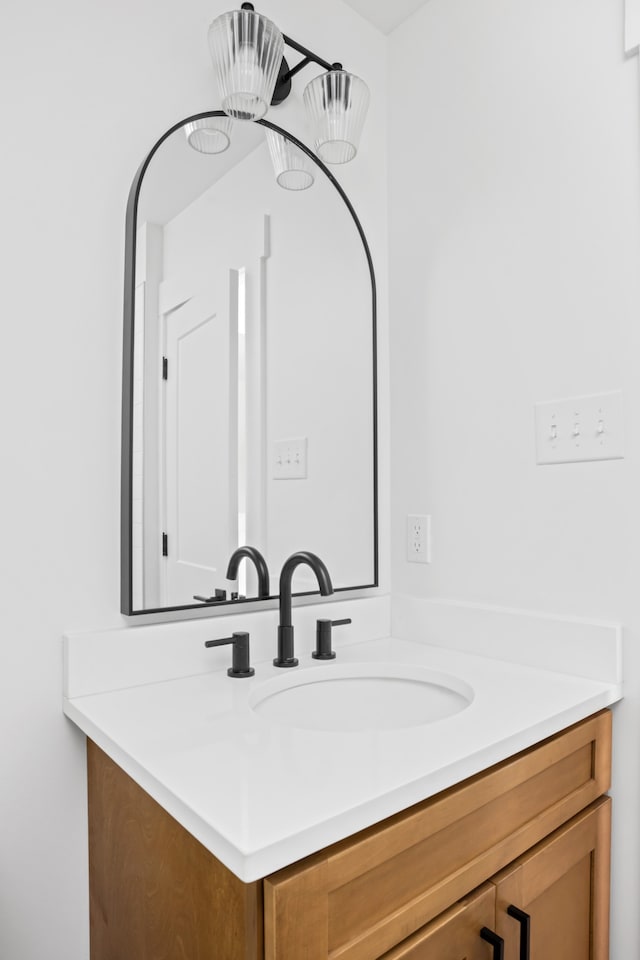 bathroom featuring vanity and a chandelier