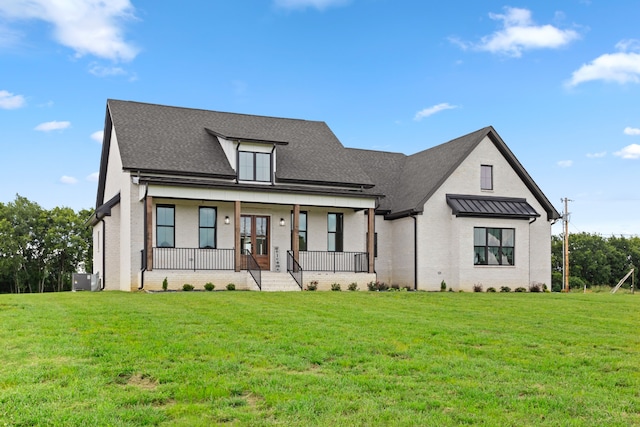 modern farmhouse style home featuring a front yard and covered porch