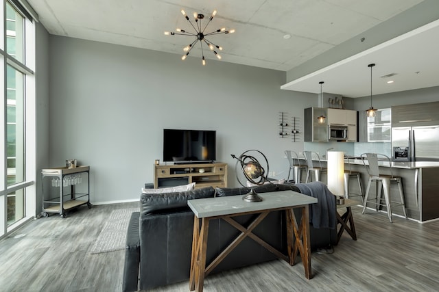 living room with a chandelier and wood-type flooring