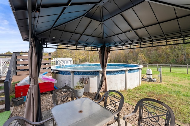 view of patio with a fenced in pool and a gazebo