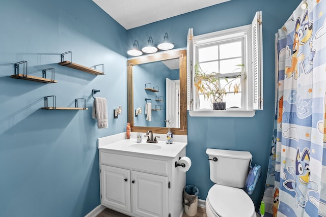 bathroom with vanity, a textured ceiling, toilet, and a shower with shower curtain