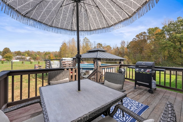 deck with area for grilling, a yard, and a gazebo