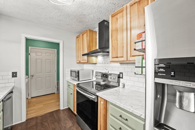 kitchen featuring dark wood-type flooring, light brown cabinets, wall chimney exhaust hood, and stainless steel appliances