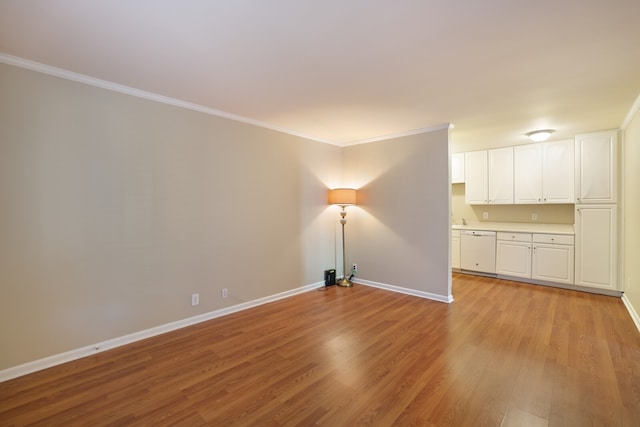 unfurnished living room with crown molding and light wood-type flooring