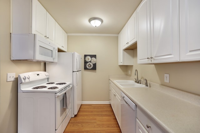 kitchen featuring crown molding, sink, light wood-type flooring, white cabinetry, and white appliances