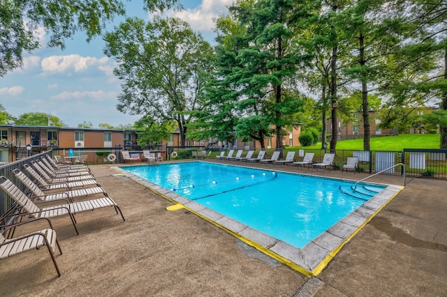 view of pool featuring a patio area and a lawn