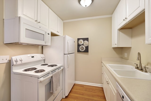 kitchen featuring white appliances, sink, white cabinetry, ornamental molding, and light hardwood / wood-style flooring