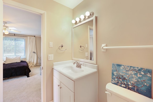 bathroom featuring vanity, toilet, and ceiling fan