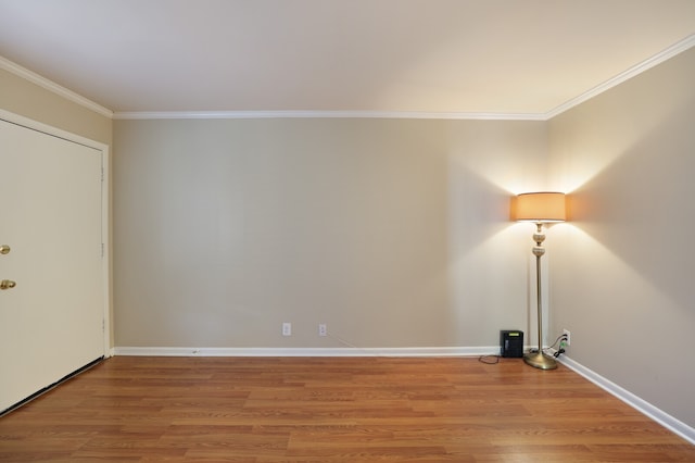 unfurnished room with crown molding and wood-type flooring