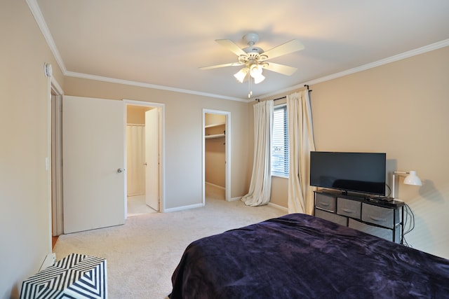 carpeted bedroom featuring a closet, ornamental molding, a spacious closet, and ceiling fan