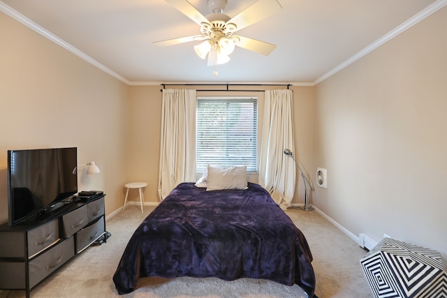 carpeted bedroom featuring ceiling fan and crown molding