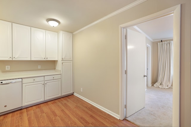 kitchen with white dishwasher, crown molding, white cabinetry, and light hardwood / wood-style flooring