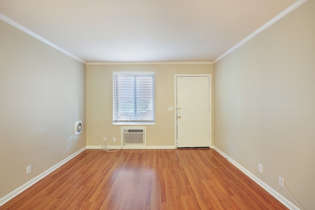 unfurnished room with crown molding, light hardwood / wood-style flooring, and a wall unit AC