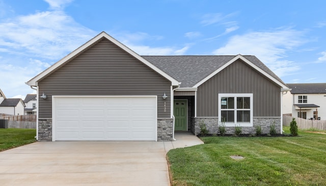 view of front of home featuring a front lawn, central AC, and a garage