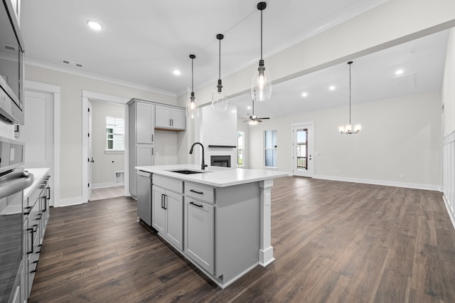 kitchen featuring a kitchen island with sink, stainless steel appliances, pendant lighting, and plenty of natural light