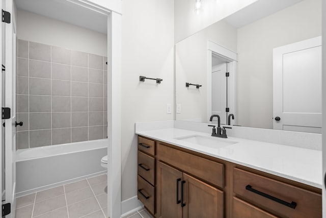 full bathroom featuring toilet, vanity, tiled shower / bath, and tile patterned floors