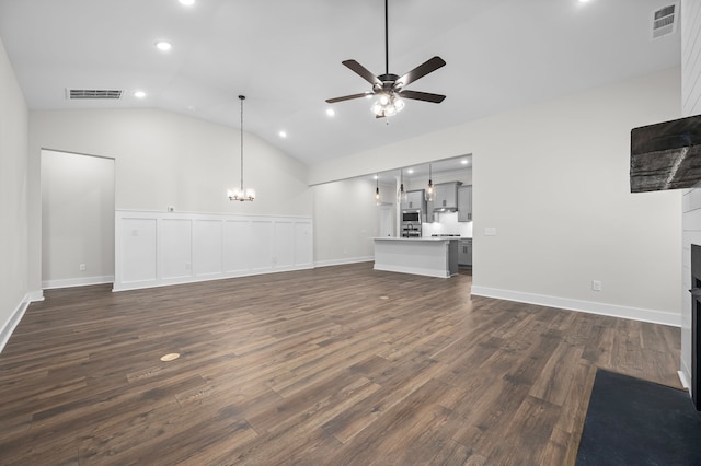 unfurnished living room featuring ceiling fan with notable chandelier, dark wood-type flooring, and lofted ceiling