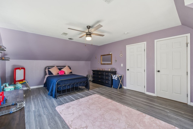 bedroom with ceiling fan, baseboards, vaulted ceiling, and dark wood-style flooring