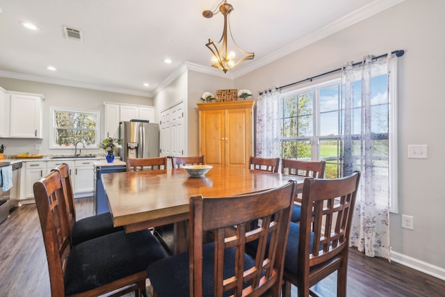 dining space featuring plenty of natural light, visible vents, dark wood finished floors, and crown molding