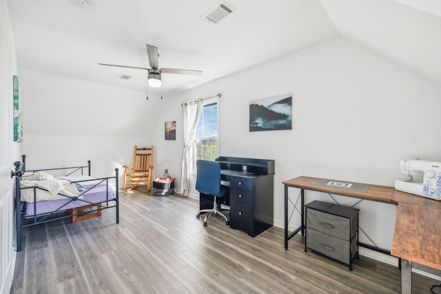 bedroom featuring lofted ceiling, wood finished floors, visible vents, and a ceiling fan